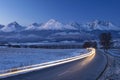 Night cars lights on the road and mountains on horizon