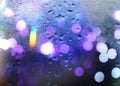 Rainy Night city blurred neon light at rainy season evening windows with rain drops lamp light background abstract template Royalty Free Stock Photo