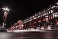 night city central avenue with illuminated historical buildings along the road and white headlight trail Royalty Free Stock Photo