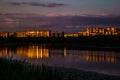 Night city. The light of houses is reflected in the water. Background. Texture. Royalty Free Stock Photo