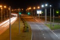 Night city light lines from cars. cars in highway with blur motion. Street view of the modern city at night. A lot of light from