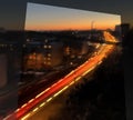 Night city light traffic in window frame , orange sunset building urban panorama Tallinn Estonia Royalty Free Stock Photo