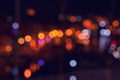 Night city lights in water reflection. Abstract warm background with blurred bokeh. Royalty Free Stock Photo