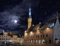 Night city medieval Tallinn old town  hall square light reflection  starry night moon and snowflakes  travel to Estonia Royalty Free Stock Photo