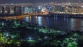 Night city near park and road with lights and high traffic aerial timelapse Royalty Free Stock Photo