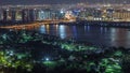 Night city near park and road with lights and high traffic aerial timelapse Royalty Free Stock Photo