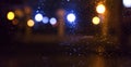 Night city, neon lights, blurred bokeh background, raindrops. Night view. Royalty Free Stock Photo