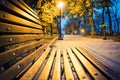 Night city park. Wooden benches, street lights Royalty Free Stock Photo