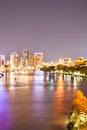 Night city photo with illuminating bright lights beside a river