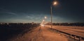 Night city road at dusk illuminated by street lamps. Royalty Free Stock Photo