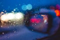 Night city road through windshield cars abstract background water drop on the glass lights and rain Royalty Free Stock Photo