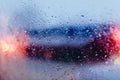 Night city road through windshield cars abstract background water drop on the glass lights and rain Royalty Free Stock Photo