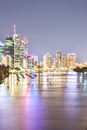 Night city sky with illuminating bright lights behind a river