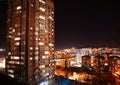 Night city with tall buildings and floating lights of cars Royalty Free Stock Photo