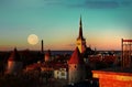 Night city  Tallinn old town red roofs medieval panorama  moon skyline  clouds blue sky sun down summer  weather Baltic sea on hor Royalty Free Stock Photo