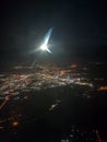 Night city under the wing of an airplane