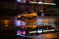 Night city view. An alone car rushes along the street of the night city. Nightlife in the city of Yakutsk