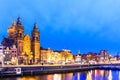 Night city view of Amsterdam canal and Basilica of Saint Nicholas Royalty Free Stock Photo