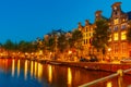 Night city view of Amsterdam canal and bridge Royalty Free Stock Photo