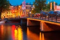 Night city view of Amsterdam canal and bridge Royalty Free Stock Photo