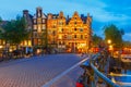 Night city view of Amsterdam canal and bridge Royalty Free Stock Photo