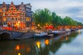 Night city view of Amsterdam canal and bridge Royalty Free Stock Photo