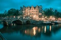 Night city view of Amsterdam canal and bridge Royalty Free Stock Photo