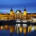 Night city view of Amsterdam canal and Centraal Station Royalty Free Stock Photo