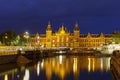 Night city view of Amsterdam canal and Centraal Station Royalty Free Stock Photo