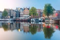 Night city view of Amsterdam canal with dutch houses