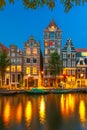 Night city view of Amsterdam canal with dutch houses Royalty Free Stock Photo