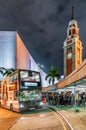 Night city view of Tsim Sha Tsui bus station, Old Clock Tower and the Hong Kong Cultural Center building Royalty Free Stock Photo