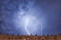 Night city view under thunderstorm with strike of lightning. Royalty Free Stock Photo