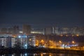 Night cityscape of the big city. Bright, multi colored light on empty streets. Apartment buildings in bedroom town area. Kyiv in Royalty Free Stock Photo