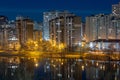 Night cityscape of the big city. Bright, multi colored light on empty streets. Apartment buildings in bedroom town area. Kyiv in Royalty Free Stock Photo