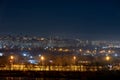 Night cityscape of the big city. Bright, multi colored light on empty streets. Apartment buildings in bedroom town area. Kyiv in Royalty Free Stock Photo