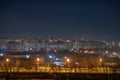 Night cityscape of the big city. Bright, multi colored light on empty streets. Apartment buildings in bedroom town area. Kyiv in Royalty Free Stock Photo