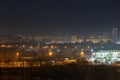 Night cityscape of the big city. Bright, multi colored light on empty streets. Apartment buildings in bedroom town area. Kyiv in Royalty Free Stock Photo