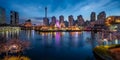 Night cityscape with cherry blossom park and tower