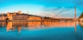 night cityscape with illuminated Courthouse and red pedestrian bridge over Saone river. Panoramic blue hour landscape Royalty Free Stock Photo