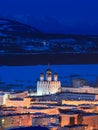 Night cityscape with a large church. Bright street lighting at dusk.