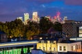 Night cityscape of London with train light trails and traditional living building on foreground and downtown skyline on background Royalty Free Stock Photo