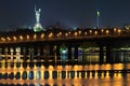 Night cityscape panorama of illuminated Paton bridge over Dnieper river. Famous Motherland monument at the background Royalty Free Stock Photo