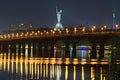 Night cityscape with Paton bridge over Dnieper river. Famous Motherland monument at the background Royalty Free Stock Photo