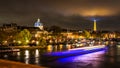 Night cityscape scene in Paris over the Seine river with the Eiffel Tower in background