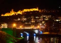 Night cityscape of Tbilisi with illuminated fortess,bridge and river reflections Royalty Free Stock Photo