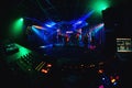 Night club with dancing people on dance floor, revelers at a party and music Board of the DJ