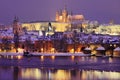 Night colorful snowy Prague gothic Castle with Charles Bridge Royalty Free Stock Photo