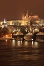 Night colorful snowy Prague gothic Castle with Charles Bridge Royalty Free Stock Photo