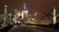 Night colorful snowy Prague gothic Castle and St. Nicholas' Cathedral from Charles Bridge, Czech republic Royalty Free Stock Photo